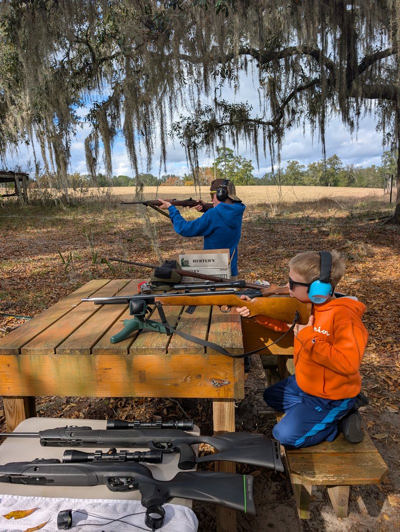 Dr. Graham's children target shooting under Spanish moss — passing down the family hunting tradition